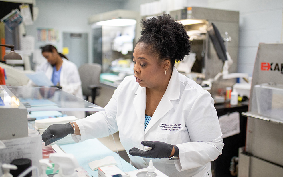 African American pathologist working in the lab